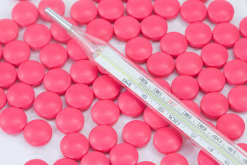 mercury thermometer and pills background