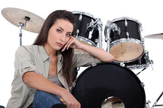 Brunette sat in front of drum kit