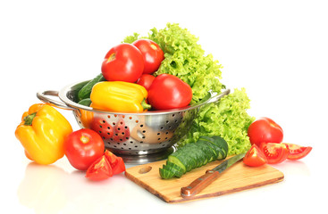 fresh vegetables and knife on cutting board isolated on white