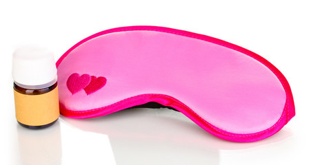 Sleeping mask and tablets isolated on white