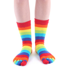 female legs in colorful striped socks isolated on white