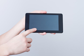 hands holding tablet