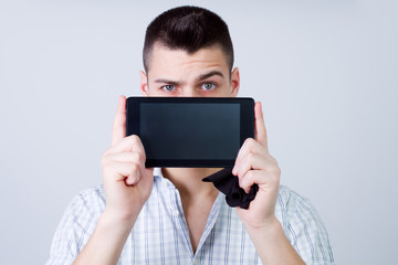 portrait of young man showing a digital tablet