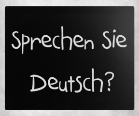 "Sprechen Sie Deutsch?" handwritten with white chalk on a blackb