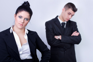 modern young business couple posing on gray background