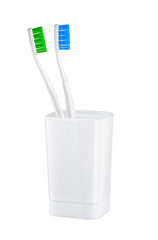 toothbrushes in glass on a white background