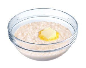 Oatmeal in a glass bowl on white background