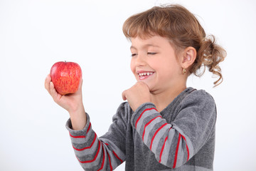 portrait of a little girl with an apple