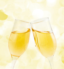 Two glasses of champagne with lights in the background