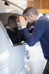 Fototapeta premium Customer looking inside a car
