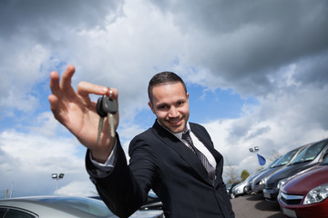 Happy seller holding car keys