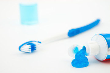 Close up of a toothbrush next to a tube of toothpaste