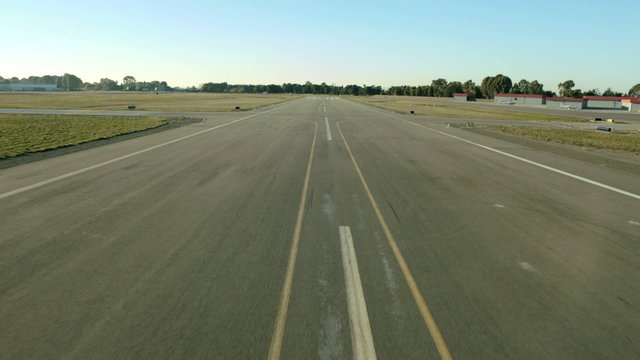 Aerial view of a plane landing and taxiing
