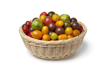 Basket with different color organic tomatoes