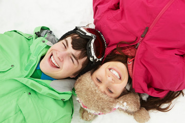 Overhead View Of Two Teenagers On Ski Holiday In Mountains