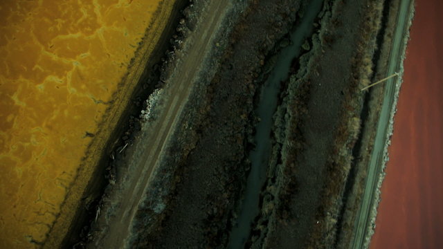 Aerial view of rich coloured natural salt evaporation ponds 