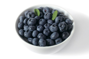 blueberries with leaves in a cup