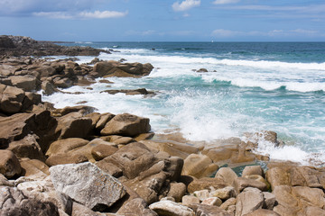 Fototapeta na wymiar Waves breaking at rocky coast of Brittany, France