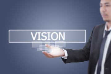 Obraz premium Businessman holding Vision word on the whiteboard.