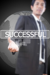 Businessman holding Successful word on the whiteboard.