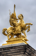 Fototapeta na wymiar golden statue on Pont Alexandre Bridge, Paris, France