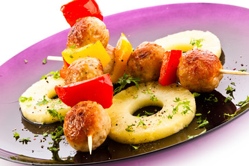 Grilled meat and vegetables on white background