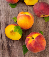 Fresh peaches on wooden table, top view
