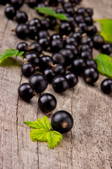 Fresh black currant on wooden table