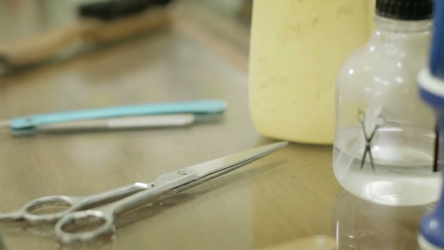 Closeup of tools, scissors, blade and razor in barber shop