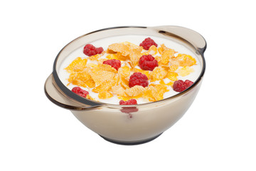 Corn flakes with milk and raspberry in a black dish