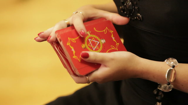 Woman shuffling a deck of taro cards