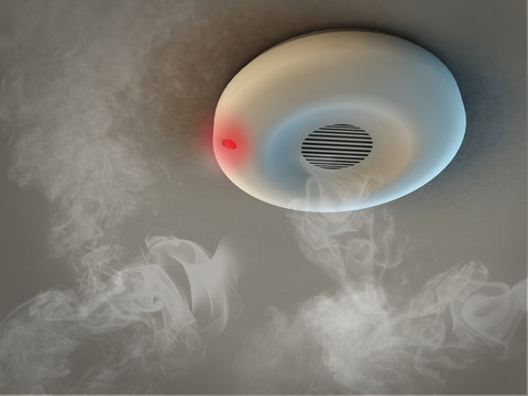 Smoke detector on ceiling detects smoke and give alarm