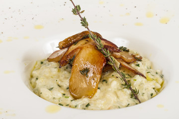 photo of delicious risotto dish with herbs and mushrooms on whit