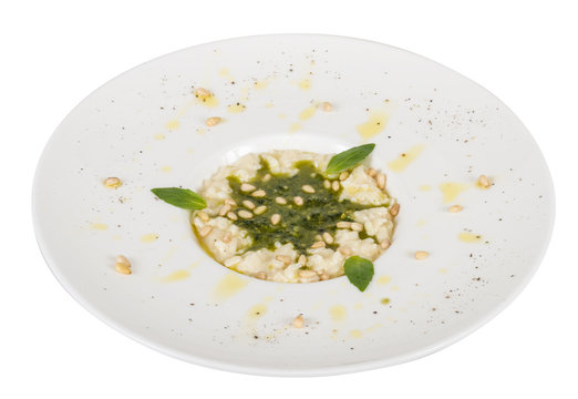 photo of delicious risotto dish with herbs and cedar nut on whit