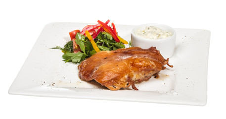 roasted chicken with vegetables on a white plate