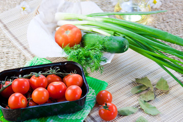 ripe red tomatoes and fresh greenery