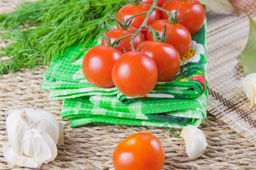 red ripe tomatoes with fresh greenery on a napkin