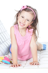 Beautiful little girl lying on a sofa © Iuliia Metkalova