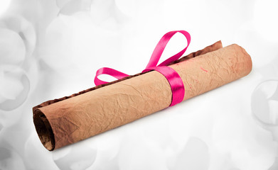 Diploma with red ribbon with lights in the background