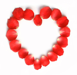 Obraz premium Red rose petals with heart shape on white background.