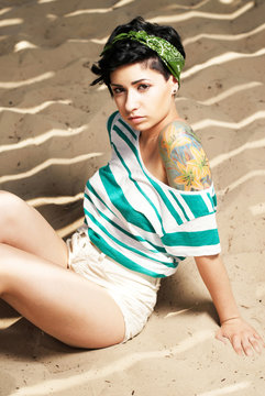 adorable girl with tattoo on the beach