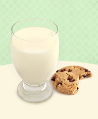 Milk and Cookie with Bite Taken on Green background