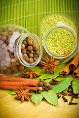 Pack of several spices and herbs in glass jars
