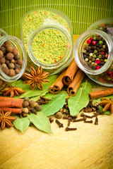 Pack of several spices and herbs in glass jars