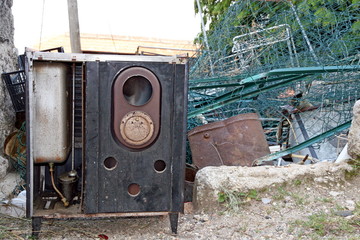 pile of scrap metal and an old stove ready to be melted down and