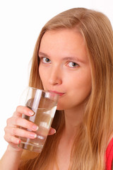 Beautiful young woman drinking water