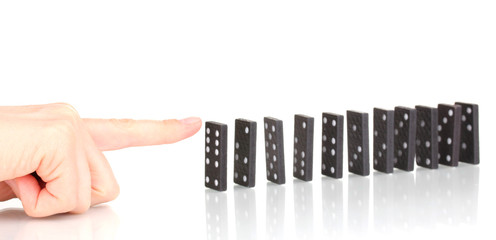 Hand pushing dominoes isolated on white