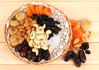 different dried fruits on wooden background