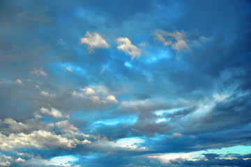 Background of deep blue sky with fluffy clouds