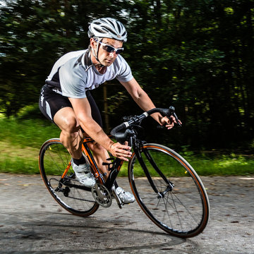 Rennradfahrer in rasanter Kurvenfahrt